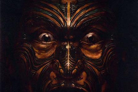 Tribal-themed wargames rulebook with a face design and text on a dark background